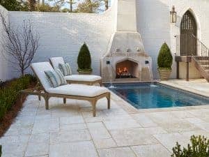 Peacock Pavers around an outdoor pool and fireplace, styled in a Basic Random Pattern.